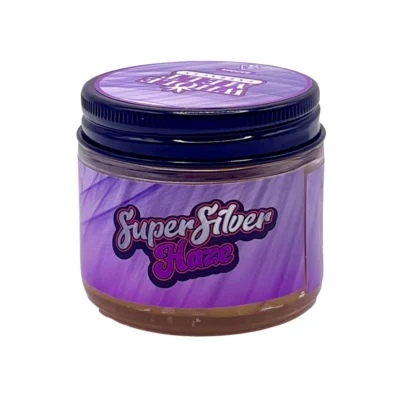 Creamy blonde hue of authentic Whole Melt Super Silver Haze Extracts badder concentrate inside a premium glass jar.