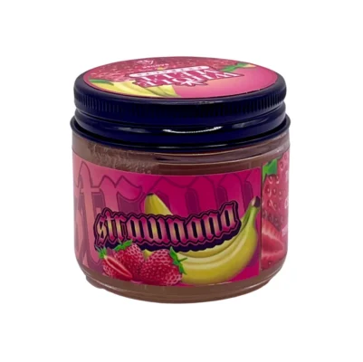 Creamy golden hue of authentic Whole Melt Strawnana Extracts badder concentrate inside a premium glass jar.