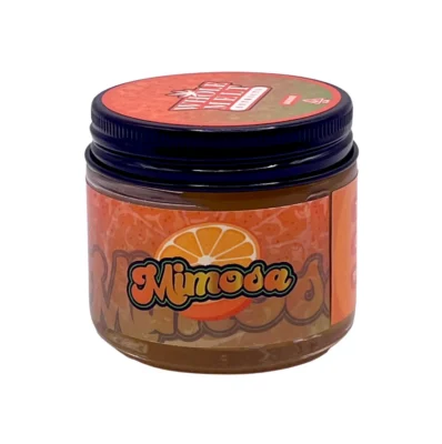 Creamy golden hue of authentic Whole Melt Mimosas Extracts badder concentrate inside a premium jar.