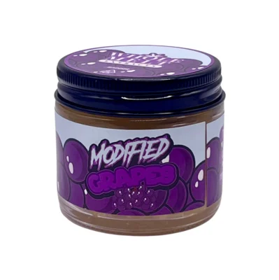Creamy golden hue of authentic Whole Melt Modified Grapes Extracts badder concentrate inside a premium glass jar.