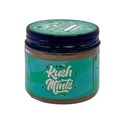 Creamy golden texture of authentic Whole Melt Kush Mintz Extracts badder concentrate jar with verification packaging.